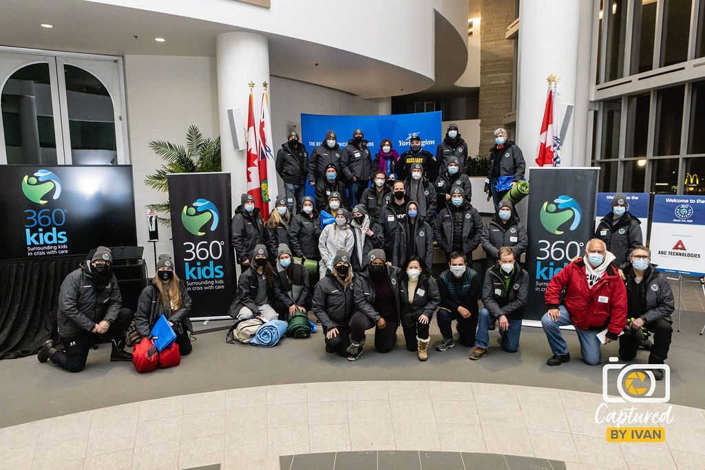 Group photo of 360Experience particpants in matching grey jackets and hats
